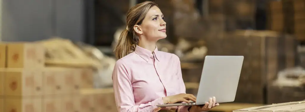 Mulher trabalhando na cadeia de abastecimento com notebook